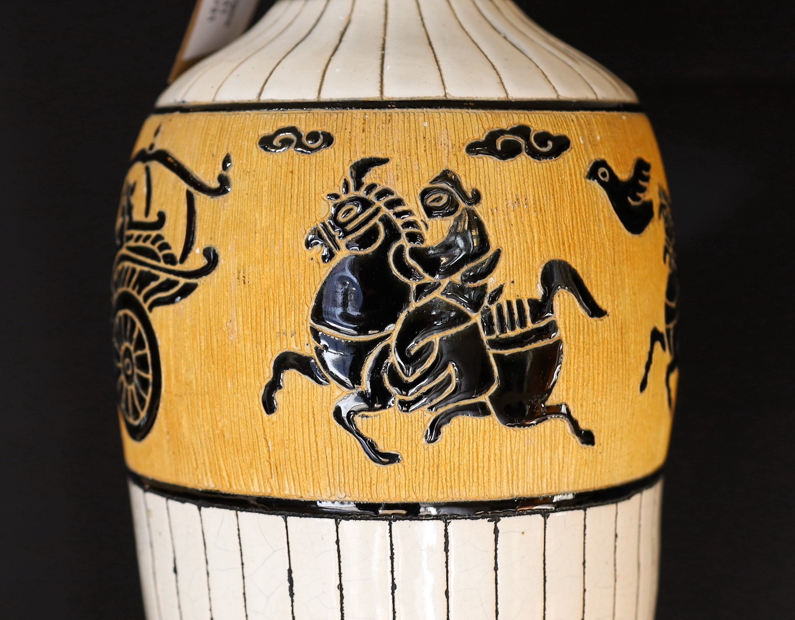 A 20th century Continental tinglazed pottery table lamp, decorated within a band of horse riders and birds, height without shade 62cm